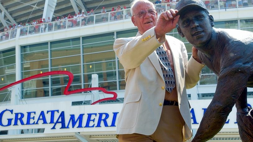 Joe Nuxhall tugs on the bill of the cap of the statue dedicated in his honor at Great American Ballpark, before the Cincinnati Reds vs Astro' game July 20, 2003. TONY TRIBBLE/JOURNALNEWS