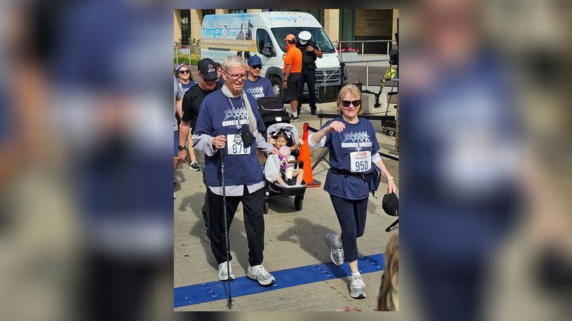 Dale Brown, 75, of Middletown, and his girlfriend, Ruth Blom, cross the finish line Monday of the 3.1-mile Hunger Walk in Cincinnati. SUBMIITTED PHOTO