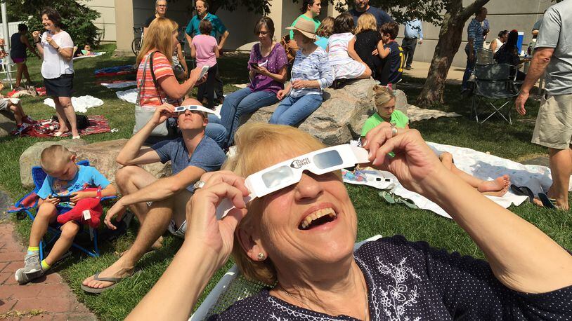 People of all ages turned out at the Boonshoft Museum of Discovery on Monday to watch the solar eclipse. CHRIS STEWART / STAFF