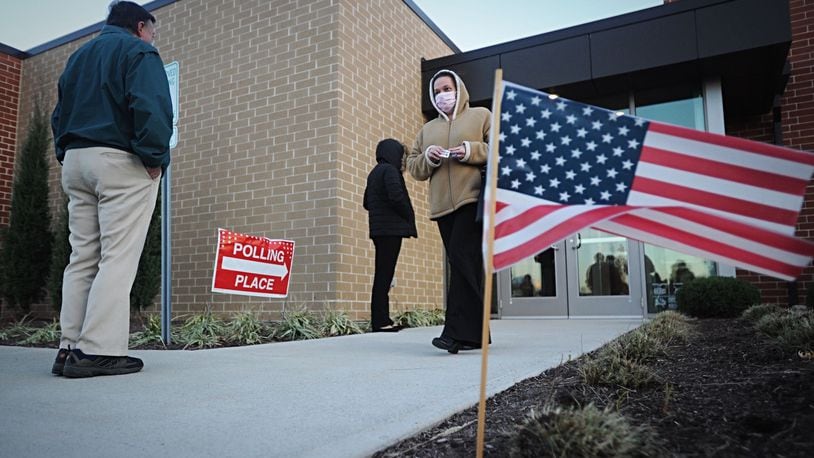Voters lineup on Election Day outside the Southeast branch of the Dayton Metro Library at 21 Watervliet Ave. MARSHALL GORBY\STAFF