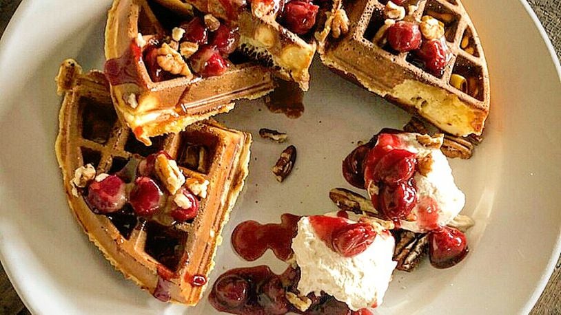 Mudlick's bourbon soaked cherries over a Belgian waffle, roasted pecans, salted caramel whip. CONTRIBUTED