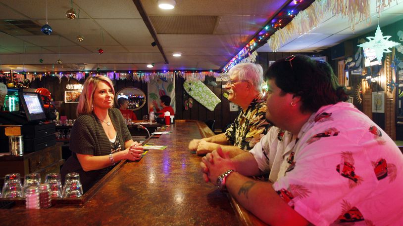 ARCHIVED PHOTO from 2011:  Bartender Dawn Booher, left, talks with co-owners Larry Parr, middle, and Eddie Holbrook, right, inside of  the Paradise Key Cafe  on Needmore Road in Dayton.