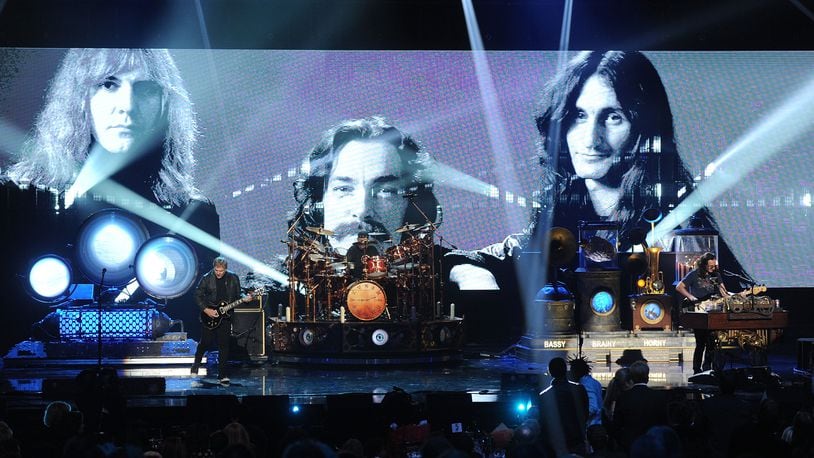LOS ANGELES, CA - APRIL 18:  (L-R) Inductee Alex Lifeson, Neil Peart, and Geddy Lee of Rush perform on stage at the 28th Annual Rock and Roll Hall of Fame Induction Ceremony at Nokia Theatre L.A. Live on April 18, 2013 in Los Angeles, California.  (Photo by Kevin Winter/Getty Images)