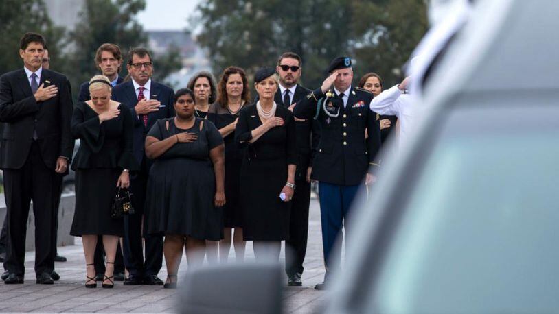 WASHINGTON, DC - SEPTEMBER 1: Members of the McCain family watch joint service members of a military casket team carry the casket of Senator John McCain from the US Capitol to a motorcade that will ferry him to a funeral service at the National Cathedral on September 1, 2018 in Washington, DC. The late senator died August 25 at the age of 81 after a long battle with brain cancer. McCain will be buried at his final resting place at the U.S. Naval Academy. (Photo by Jim Lo Scalzo-Pool/Getty Images)