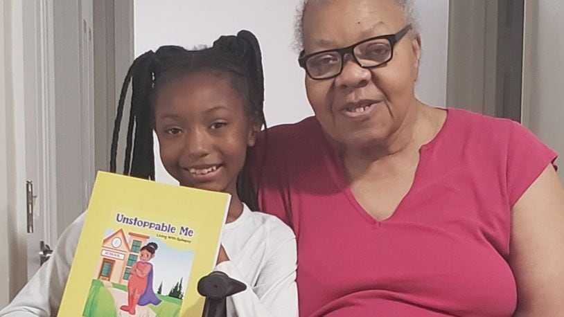 Jordynn Farley (left) of Trotwood holds book that she wrote withe the editing assistance of her grandmother, Francis Marr, a retired Dayton teacher. CONTRIBUTED PHOTOS