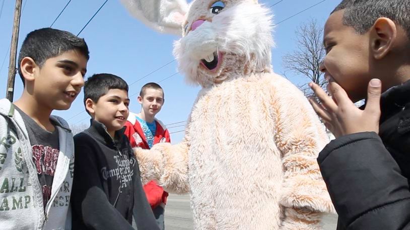 The Esther Price Easter Bunny, aka Loretta Young of Moraine, meets with children and draws traffic into the Wayne Avenue store in Dayton on Friday, March 29. The bunny will be back at the store from noon-5 p.m. Saturday. CHRIS STEWART / STAFF