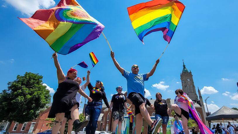 Matthew Heinrich dances with flags on stage during Hamilton's first Pride event Saturday, June 5, 2021. A parade kicked off the festivities and ended at Marcum Park with vendors, food, and music. NICK GRAHAM/FILE