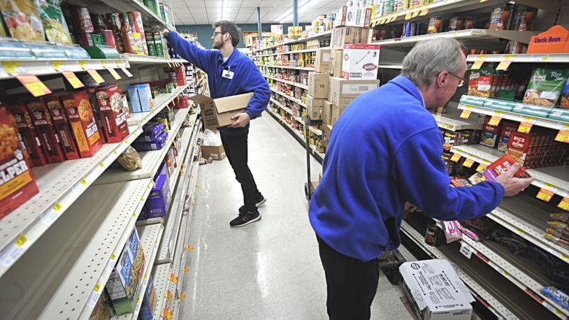 Dots Market employees, left, Max Sands and Bob Brown, along with others have been working seven days week to help the store stay stocked up for customers. MARSHALL GORBYSTAFF