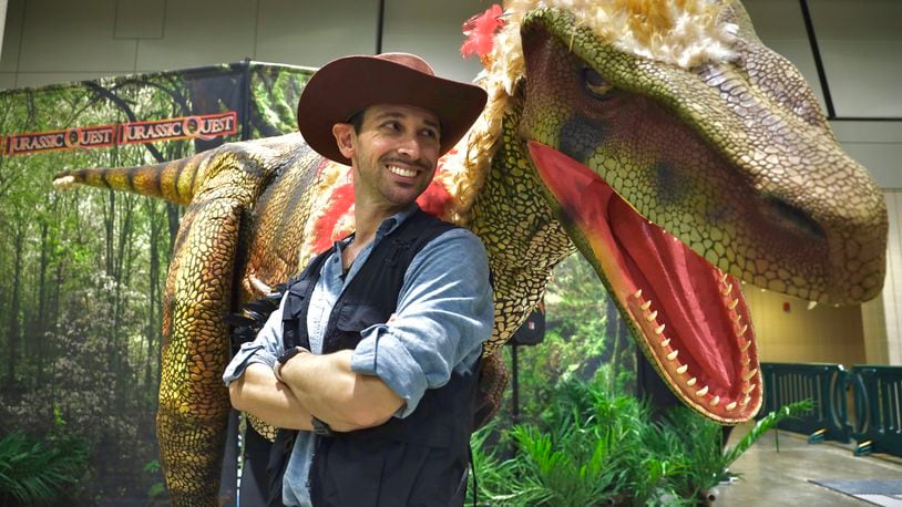 One of the Jurassic Quest trainers with a raptor (CONTRIBUTED BY JURASSIC QUEST)