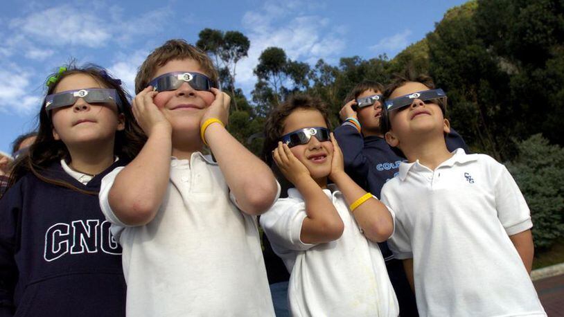 Students view a partial solar eclipse at a school in Bogota, Colombia in 2005. (AP Photo/Zoe Selsky)