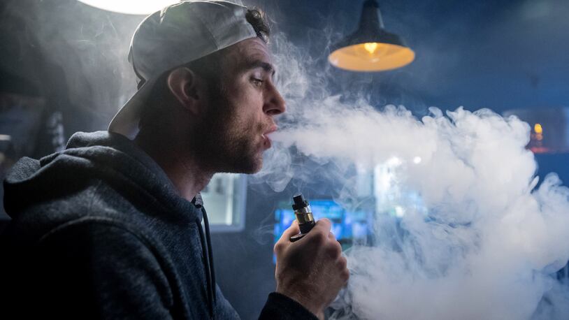 BRISTOL, ENGLAND - DECEMBER 30:  Mitchell Baker who works at the Vapour Place a vaping shop in Bedminster, exhales vapor produced by an e-cigarette on December 30, 2016 in Bristol, England. Recent figures released by the e-cigarette industry has claimed that there as many as 1700 vaping shops across the country, with two new ones opening each day catering for the estimated three million vapers in the UK. The popularity of e-cigarettes has boomed in the last ten years, as it is seen by many as a healthier alternative to traditional cigarettes, however some critics say the devices can carry the same risks as smoking especially as the long term affects are yet to be known.