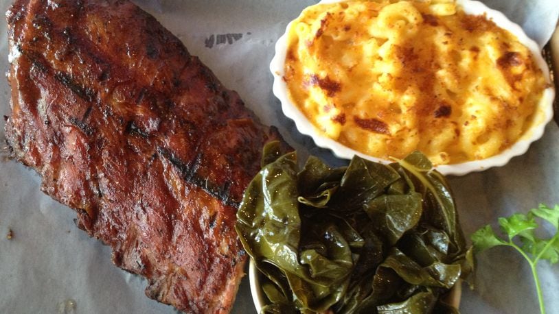 Half slab of baby back rib finished on the grill with a mild Memphis-style sauce. Pictured with collard greens and macaroni and cheese, $16.99. (Staff photo by Amelia Robinson)