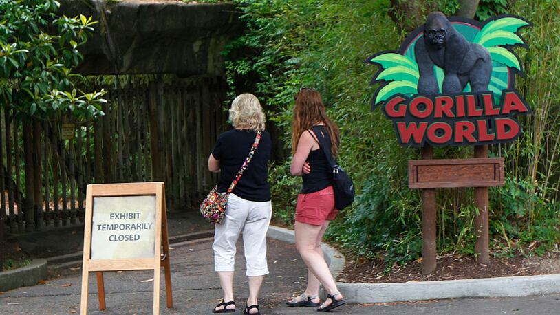 CINCINNATI, OH - JUNE 2: Visitors walk past the closed main entrance to the Cincinnati Zoo's Gorilla World exhibit days after a 3-year-old boy fell into the moat and officials were forced to kill Harambe, a 17-year-old Western lowland silverback gorilla June 2, 2016 in Cincinnati, Ohio. The exhibit remained closed as zoo officials worked to upgrade safety features of the exhibit.  (Photo by John Sommers II/Getty Images)