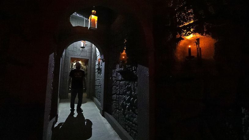 A worker stands in a doorway of the new wine cellar added to the Face Your Fears Hotel of Terror this year. BILL LACKEY/STAFF