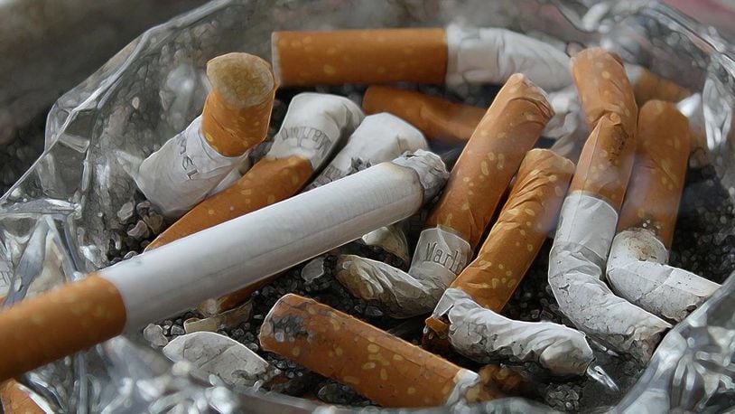 An Alabama man got into trouble with authories when he tossed cigarettes to inmates doing a work detail.