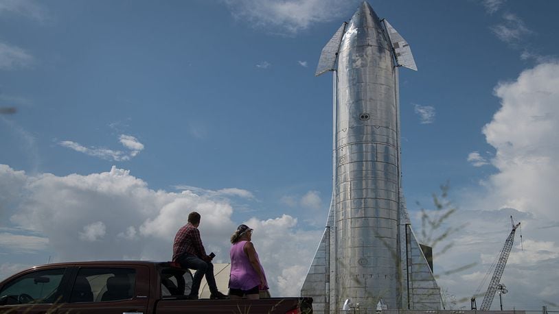 Space enthusiasts look at a prototype of SpaceX's Starship spacecraft at the company's Texas launch facility on Sept. 28, 2019, in Boca Chica near Brownsville, Texas.