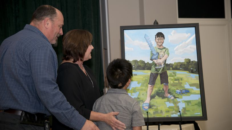 Xin Farley of Centerville, son of Angie and Julian Farley, was painted by professional, internationally-recognized artist Kevin Muente. The Farley family took home the original painting to display atop Xin’s bedroom book shelf, while a replica of the portrait will be displayed inside Shriners alongside the other three portraits.