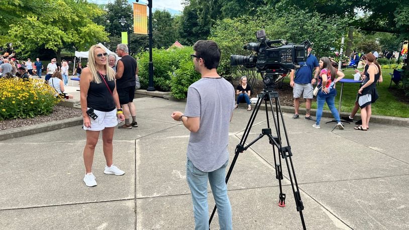 Amy Zahora speaking to a news crew at Bacon Fest 2022. ALEXIS LARSEN/CONTRIBUTED
