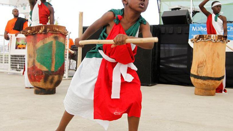 Pascal Ndayishimi, 6, dances with the Burundian Royal Court Drummers during the opening ceremony of the annual Dayton African American Cultural Festival at Riverscape in downtown Dayton on Saturday, August 24, 2013. Barbara J. Perenic/Staff