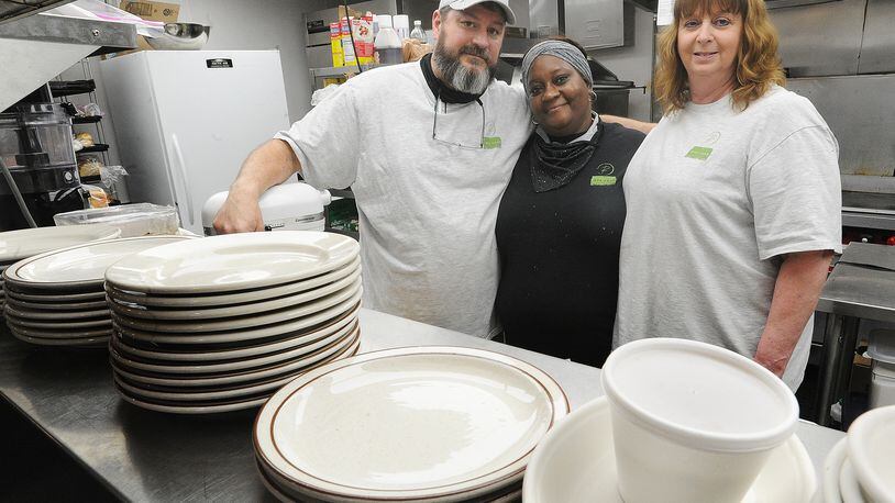 Chef Tom Tiner (left), owner of the newly opened Rye Toast Diner in Miamisburg, is shown with with the restaurant's cook, Delonda Slocum, and his wife, Connie.  MARSHALL GORBY\STAFF