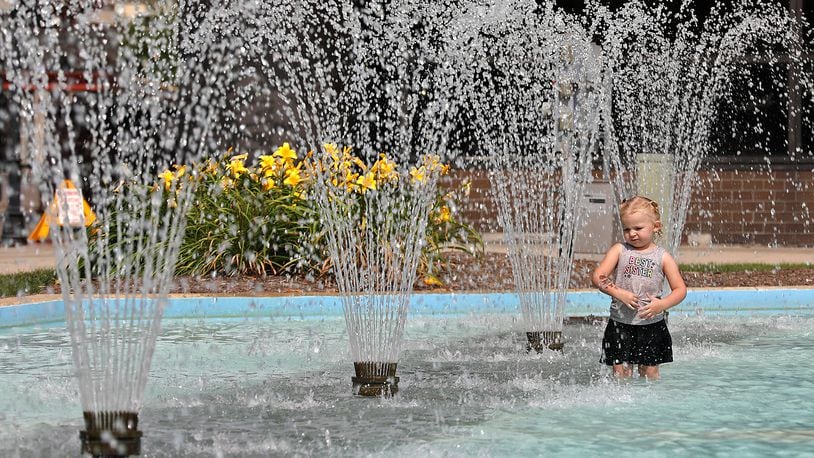 Penelope Evans cools off from the afternoon sun by wading recently in the City Hall Plaza fountain in downtown Springfield. Today will be hot and humid, which combined will make the temperature feel like it is 100 degrees or higher. BILL LACKEY/STAFF
