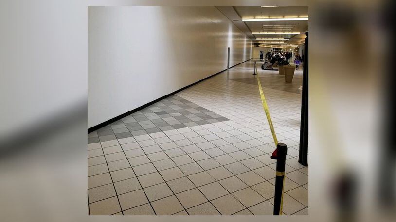 A long white wall in the Sears wing of the Dayton Mall will be the new RoomPlace store.