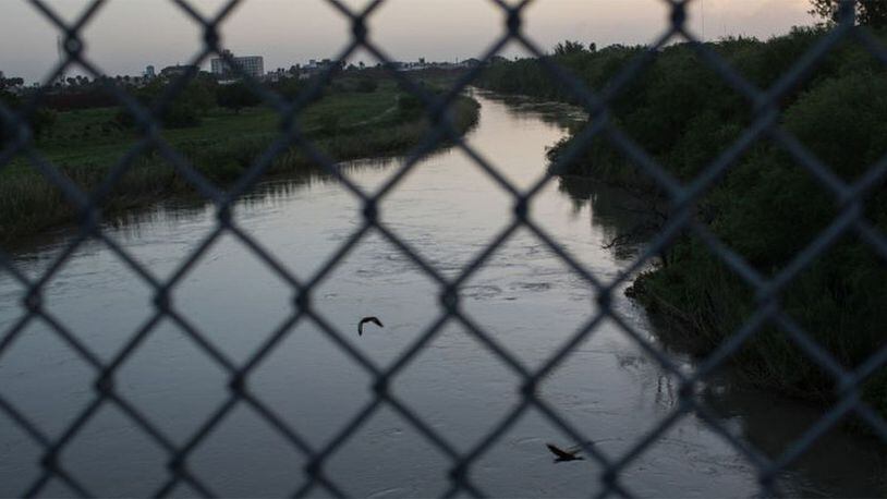 FILE PHOTO: The Rio Grande flows under the Brownsville & Matamoros International Bridge near Brownsville, Texas. A family who traveled to Mexico to visit relatives for the holidays were attacked as they drove back to the U.S. A 13-year-old was killed.