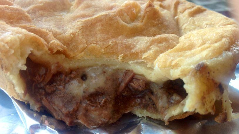 Cheeky Meat Pies Kiwi Classic — chunks of roast in an onion gravy with Monterrey Jack cheese encased in a flaky crust, $5. (Staff photo by Amelia Robinson)