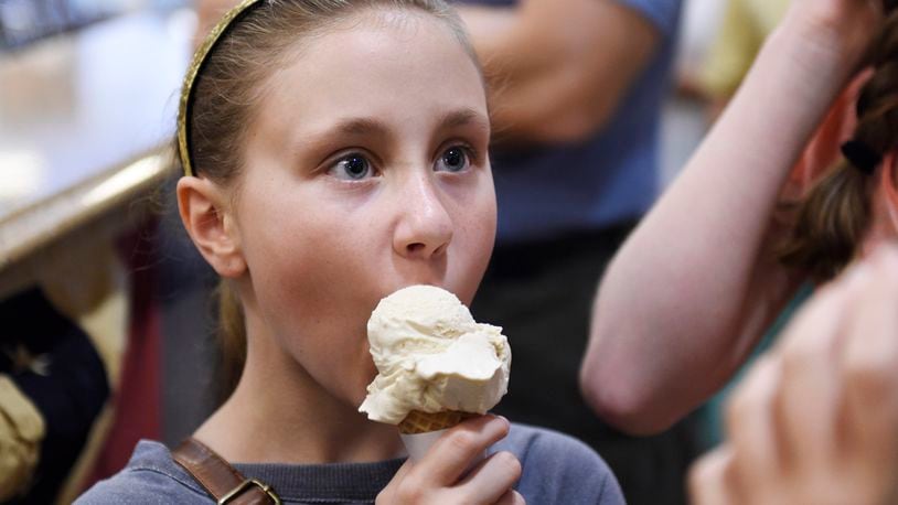 Abbie Vaughan, 11, eats an ice cream cone at Graeter’s Ice Cream in Oxford. NICK GRAHAM/STAFF
