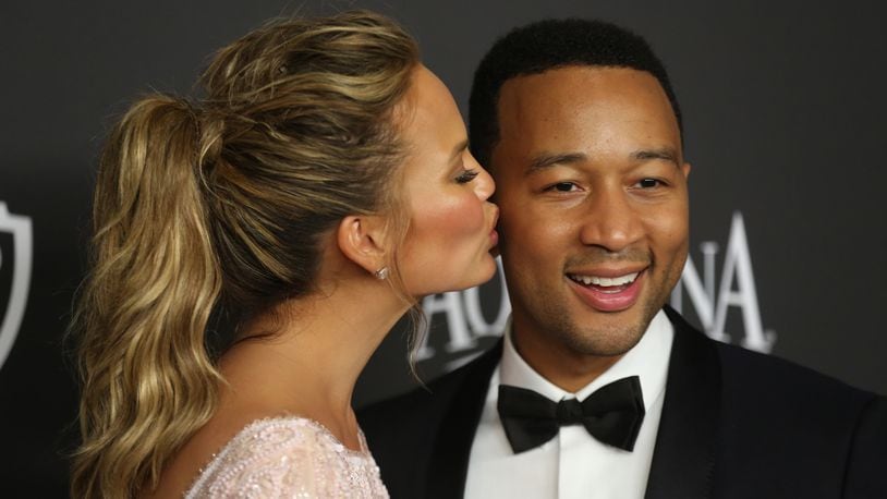 Chrissy Teigen, left, and John Legend arrive at the 16th annual InStyle and Warner Bros. Golden Globes afterparty at the Beverly Hilton Hotel on Sunday, Jan. 11, 2015, in Beverly Hills, Calif. (Photo by Matt Sayles/Invision/AP)
