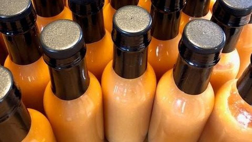Tracy and Jeffrey McElfresh of Kettering have released JuicyMelt Supreme Hot Sauce.  Varieties include Ruby Wizard (grapefruit habanero), OG Catalyst (orange ginger habanero), and All the Fun (white pepper peach). CONTRIBUTED