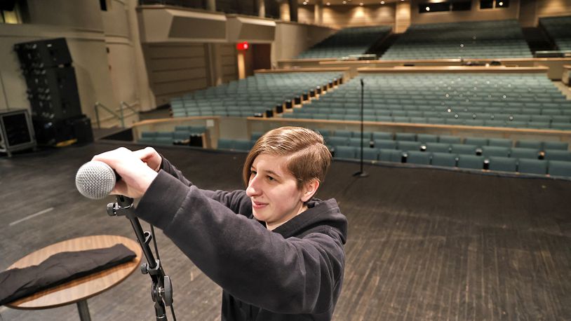 Marissa Lee sets up the microphones on stage at Kuss Auditorium on Thursday, March 16, 2023, as she and other stage personnel get ready for a show by Sheena Easton later that evening at the Clark State Performing Arts Center in Springfield. BILL LACKEY/STAFF