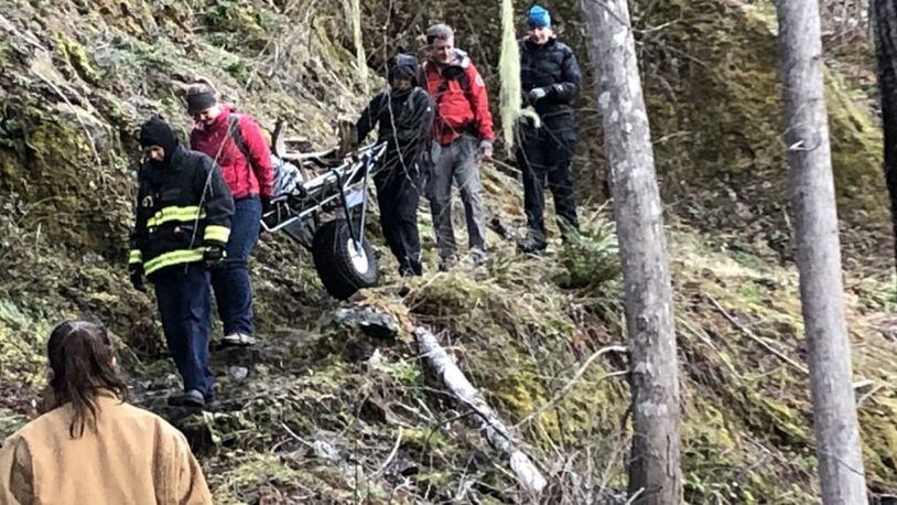 Officials wheel an injured hiker to safety Saturday morning.