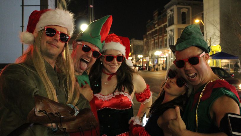 Hundreds filled the bars of Fifth Street decked out in red and green, jingle bells and holiday lights, enjoying drink specials and a rollicking costume contest for the 10th annual Santa Pub Crawl on Dec. 12, 2015. The Pub Crawl, organized by Gem City Podcast, benefited the Marines Toys For Tots Foundation campaign. VIVIENE MACHI / STAFF