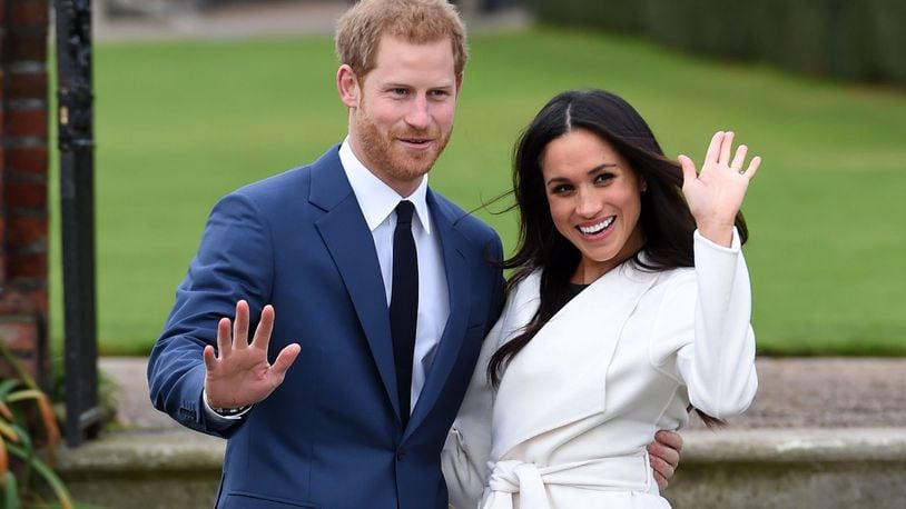 Newly-engaged Prince Harry and Meghan Markle pose during a photoshoot at Kensington Palace.