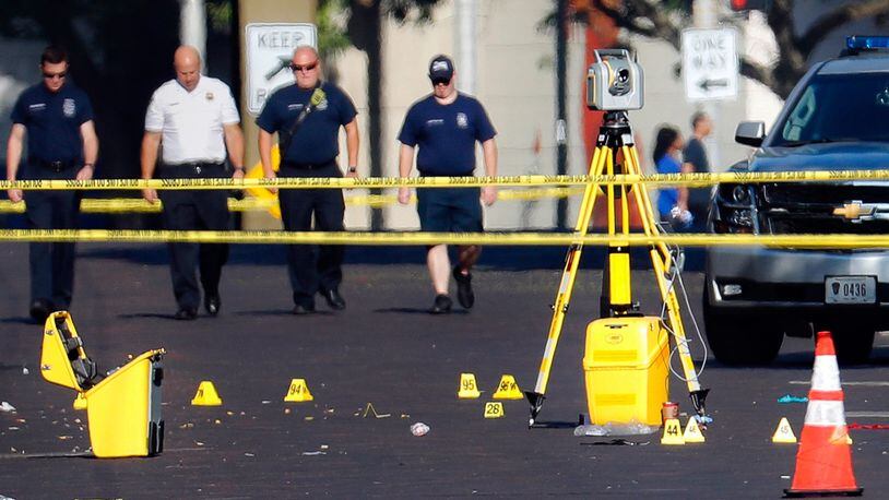 Evidence markers rest on the street at the scene of a mass shooting Sunday, Aug. 4, 2019, in Dayton, Ohio. Several people in Ohio were killed in the second mass shooting in the U.S. in less than 24 hours.