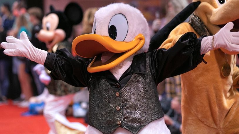 FILE PHOTO: A service dog recently melted the heart of a costumed performer portraying Donald Duck.