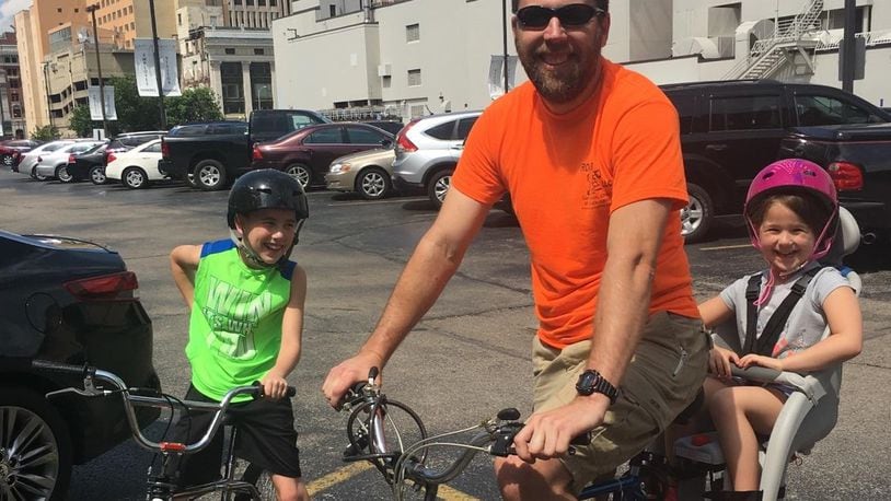 Phillip Neumann taking his niece and nephew on a bike ride around Dayton.