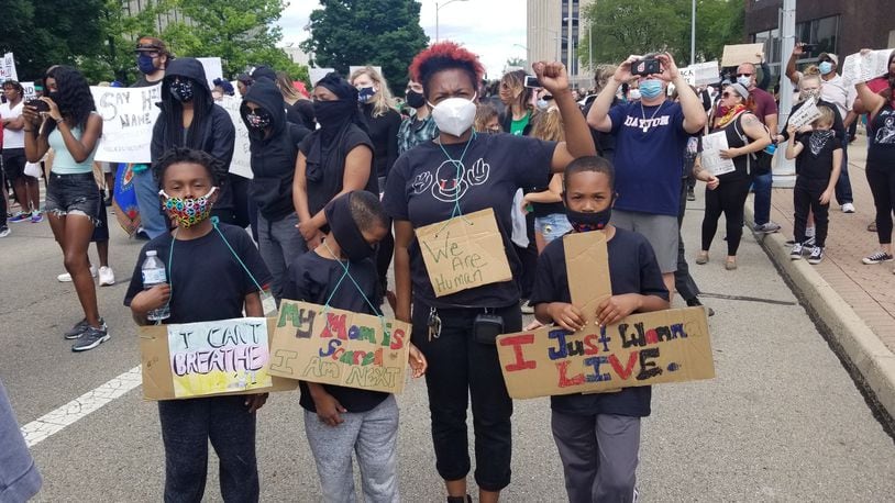 Educator Lynda Huggins protests with her three sons May 30, 2020 in downtown Dayton. CONTRIBUTED PHOTO