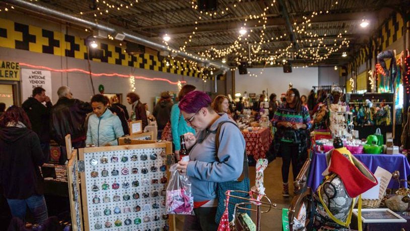 Local vendors set up shop with handmade wares to give and get for the holidays at the Yellow Cab Tavern in Dayton. TOM GILLIAM/FILE