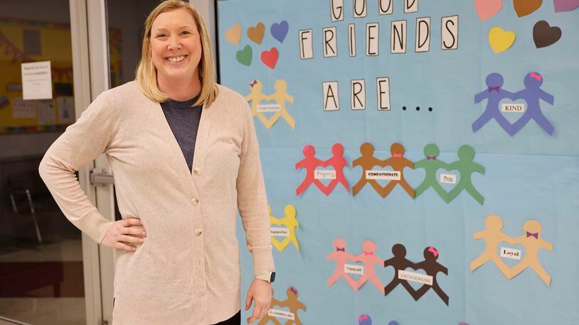 Fairfield North Elementary School Counselor Laura Monnier was and remains on the front lines of the emotional health battle pre and post-pandemic. Monnier is seen here in front of one of the many social-emotional development posters featured in the Fairfield Twp. school. NICK GRAHAM/STAFF