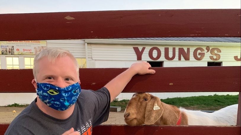 Beavercreek resident Matthew Dorn visits the farm animals on a visit to Young's Jersey Dairy in Yellow Springs.