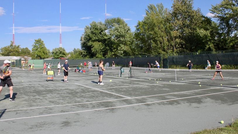Players from Kettering Tennis Center and Quail Run Racquet Club take part in a recent Live Ball clinic in Kettering. “You hit a lot more balls and get a really good workout,” said Quail Run manager Darrin Heinz. CONTRIBUTED