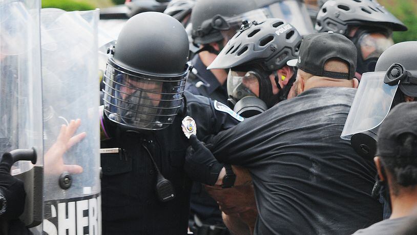 Police take down a protester on Wayne Ave. Saturday. MARSHALL GORBY\STAFF