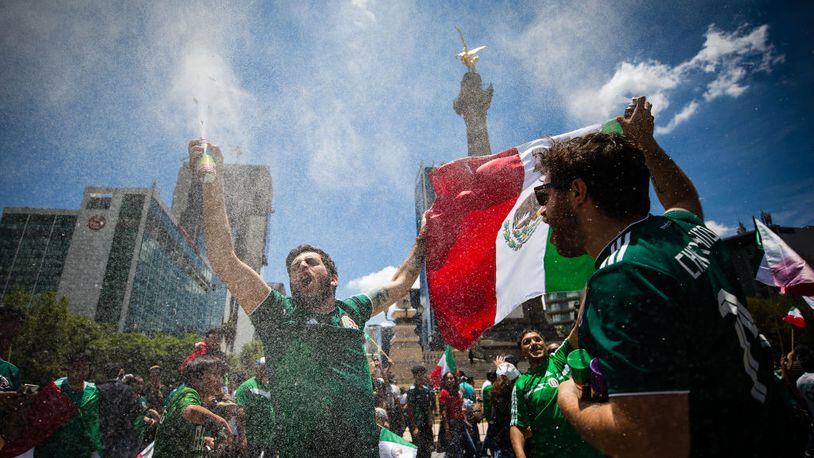 MEXICO CITY, MEXICO - JUNE 17: Mexicans celebrate at the Angel of Independence after the Mexico National Team victory over Germany in the 2018 FIFA World Cup Russia on June 17, 2018 in Mexico City, Mexico. (Photo by Manuel Velasquez / Getty Images)