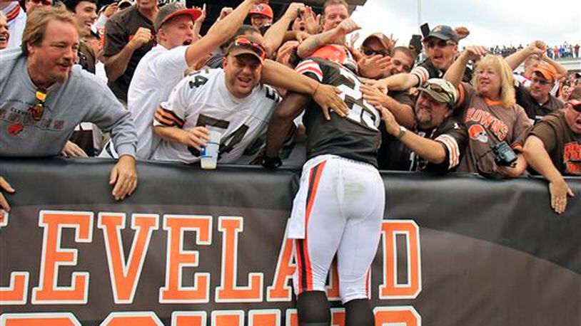 Cleveland Browns running back Chris Ogbonnaya (25) leaps into the Dawg Pound after a 1-yard touchdown catch against the Cincinnati Bengals in the fourth quarter of an NFL football game on Sunday, Sept. 29, 2013, in Cleveland. (AP Photo/Tony Dejak)