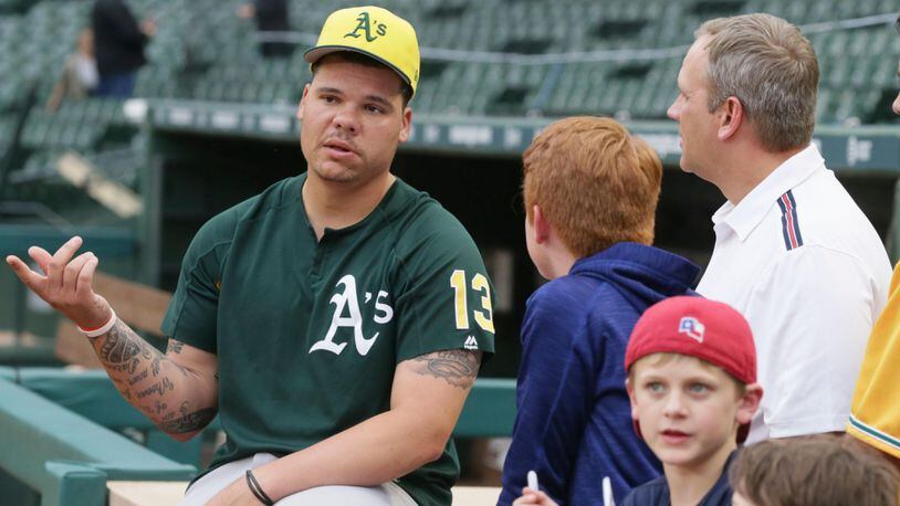 Oakland Athletics catcher Bruce Maxwell talks to fans before a baseball game against the Texas Rangers in Arlington,Texas, Friday, Sept. 29, 2017. (AP Photo/LM Otero)