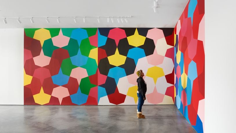 A visitor views Odili Donald Odita's mural at The Contemporary in Dayton. CONTRIBUTED