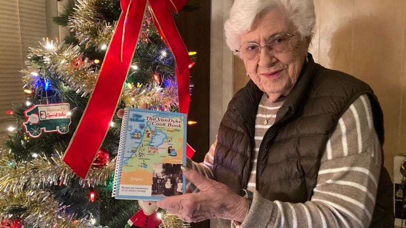 Dorothy Frysinger with a copy of her family's cookbook, The VanDyke Cook Book.