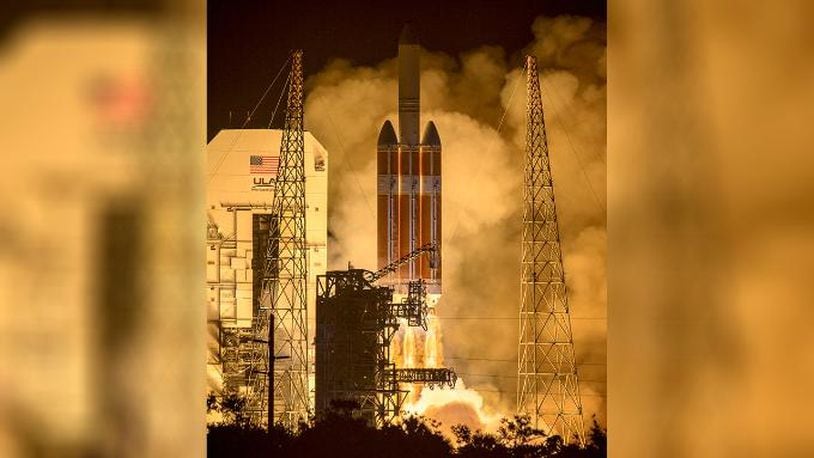 In this photo provided by NASA, The United Launch Alliance Delta IV Heavy rocket launches NASA's Parker Solar Probe to touch the Sun, Sunday, Aug. 12, 2018. (Bill Ingalls/NASA via AP)